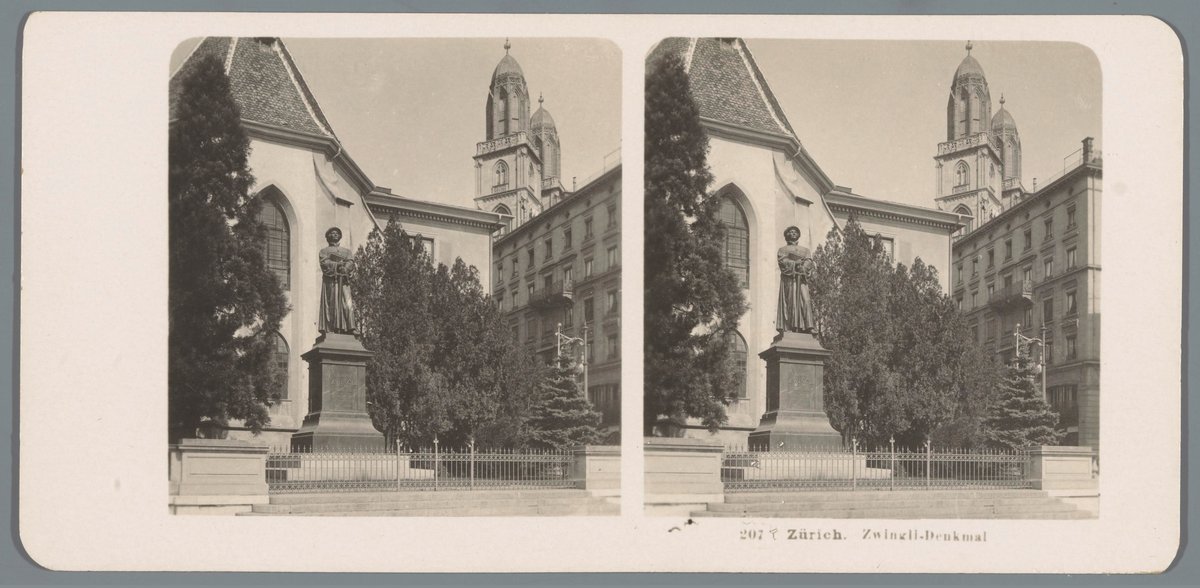 Monument of Huldrych Zwingli in Zurich front view showing statue and church facade