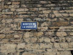 Historic plaque on Montée de la Boucle in Lyon 4e, France