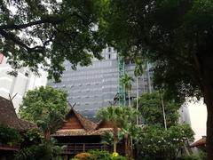 Siam Society Headquarters building in Bangkok, Thailand with colonial-style architecture and lush greenery