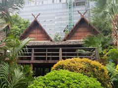 Siam Society Headquarters building in Bangkok, Thailand with cars parked in front and people walking