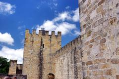 View of Castelo de São Jorge (Saint George's Castle) on a hill in Lisbon, Portugal, surrounded by city buildings