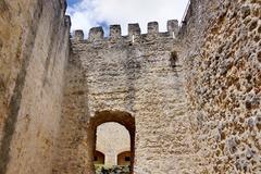 View of Castelo de São Jorge (Saint George's Castle) on a hill in Lisbon with cityscape and blue sky