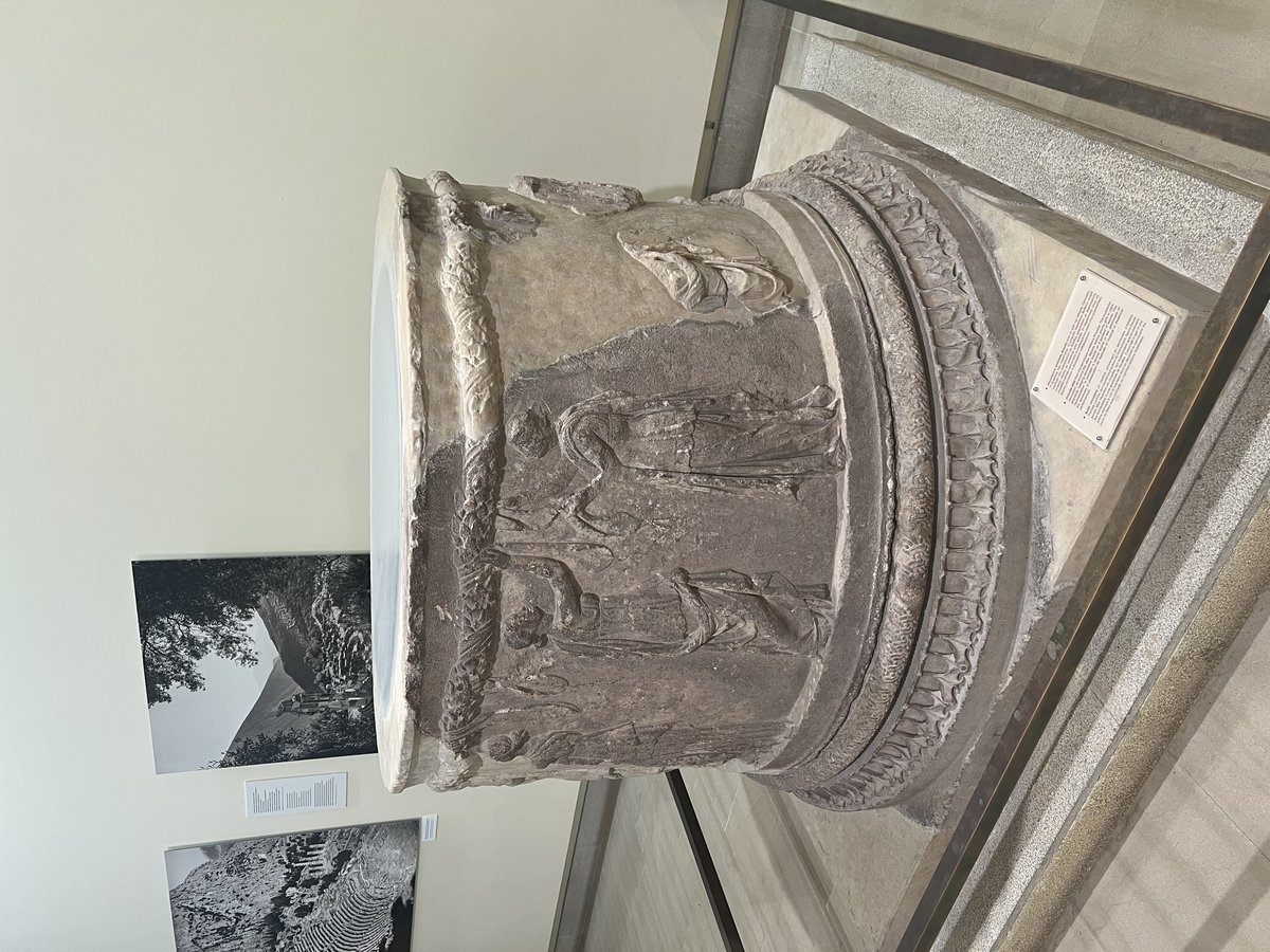 Circular altar at Delphi with stone structure and carved decorations