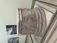 Circular altar at Delphi with stone structure and carved decorations
