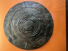 bronze votive shield with intricate designs