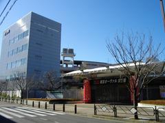 Keiokaku Velodrome outdoor cycling track with seating stands under a clear sky