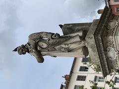 Statue of Joseph Marie Jacquard in Lyon with pigeons perched on it in April 2022