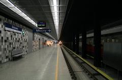 View of Młociny metro platform with approaching Russian metro carriages