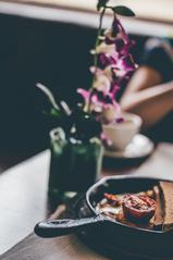 Delicious breakfast spread with flowers at Smoke House Deli in Khan Market, India