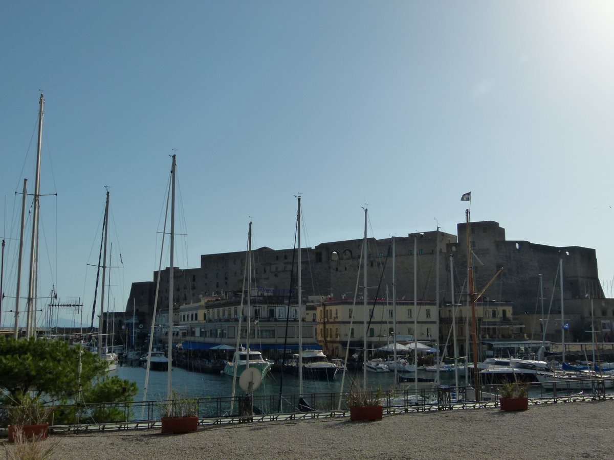 View of Borgo Marinari harbor with boats docked and buildings in the background in Naples, Italy
