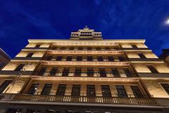 Hotel Torni in Helsinki at dusk with illuminated windows and colorful sky