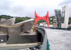 View of Puente de la Salve bridge over the river in Bilbao with modern architecture and clear sky