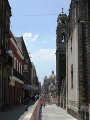 View west along Moneda Street from La Santisima Church to the Metropolitan Cathedral in Mexico City's historic center