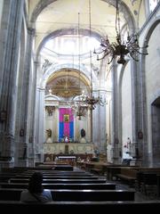 Inside view of La Santisima Church in Mexico City with colorful decorations and parishioners