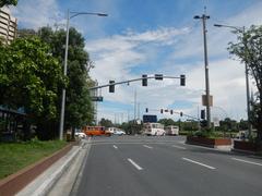 Roxas Boulevard in Malate, Manila showing busy street with vehicles and urban buildings on a sunny day