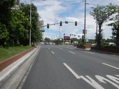 Busy city intersection at Roxas Boulevard with traffic and pedestrians in Malate, Manila