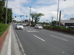 Roxas Boulevard intersection with Mabini, Ocampo, and Adriatico Streets in Malate, Manila with traffic, buildings, and pedestrians