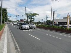 Roxas Boulevard intersection at Malate, Manila with busy streets and buildings under a clear sky