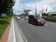 Busy street intersection with traffic and tall buildings in Malate, Manila on Roxas Boulevard