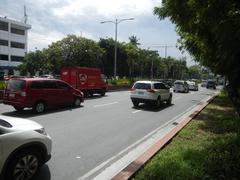 Roxas Boulevard in the Malate district of Manila showing busy street with pedestrians, vehicles, and high-rise buildings