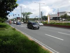 View of Roxas Boulevard street section in Malate, Manila with traffic, buildings and palm trees