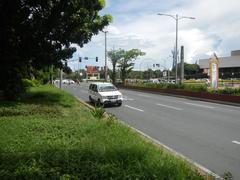 Roxas Boulevard street view in Malate, Manila with cars, street lamps and sidewalks