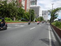 Roxas Boulevard in Malate, Manila with busy traffic and iconic buildings including Bangko Sentral ng Pilipinas and Metropolitan Museum of Manila