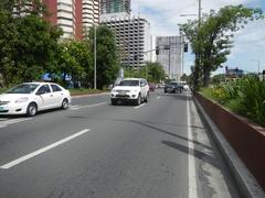 Busy street view of Roxas Boulevard in Malate, Manila with vehicles and city buildings