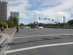 Roxas Boulevard in Malate, Manila featuring busy urban streets with cars and palm trees along the waterfront promenade