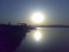 Sunrise over Rawal Lake with cityscape and hills in Islamabad