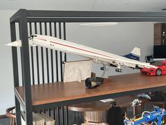 Lego Concorde model with retractable landing gear and interior, displayed with Lego F40 in the background