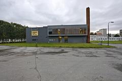 Front view of Hålogaland teater building in Tromsø with modern architecture under blue sky