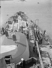 Greek Independence Day celebration aboard the cruiser HHMS Giorgios Averoff, featuring sailors on the quarterdeck in Port Said, 1943