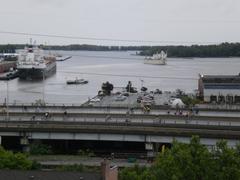 Lake freighter passing under Gardiner Expressway with bicycles on the expressway during closure in Toronto