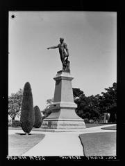 Statue of Colonel Light in a park with trees