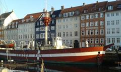 Colorful buildings along the Nyhavn harbor in Copenhagen with boats docked