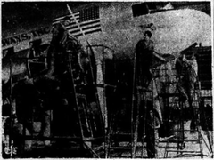 Mechanics from Panagra inspecting engines and accessories of a Douglas DC-3 aircraft