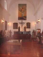 Interior room of San Carlos Convent with antique wooden furniture and religious artifacts