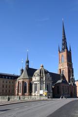 Riddarholmskyrkan church in Stockholm with a tall spire against a clear sky