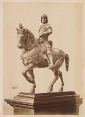 Metal sculpture of a horse rider mounted on a horse