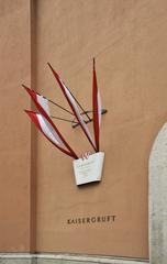 Signboard and flags at the entry of the Kaisergruft Imperial Crypt in Vienna Austria