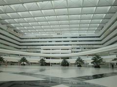 Interior view of main hall at Chaeng Watthana Government Complex in Bangkok, Thailand showing modern architecture and lighting
