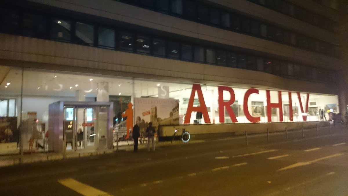 Night view of Cologne City Archive during Kölner Museumsnacht 2016 with illuminated building and people outside