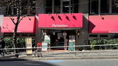Interior view of Cafe Parisienne on the first floor of Furinkai-kan building with cozy seating and warm lighting