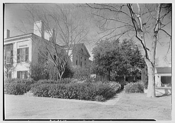 Mr. and Mrs. Edgar B. Stern standing in front of their residence at 11 Garden Lane, New Orleans, Louisiana