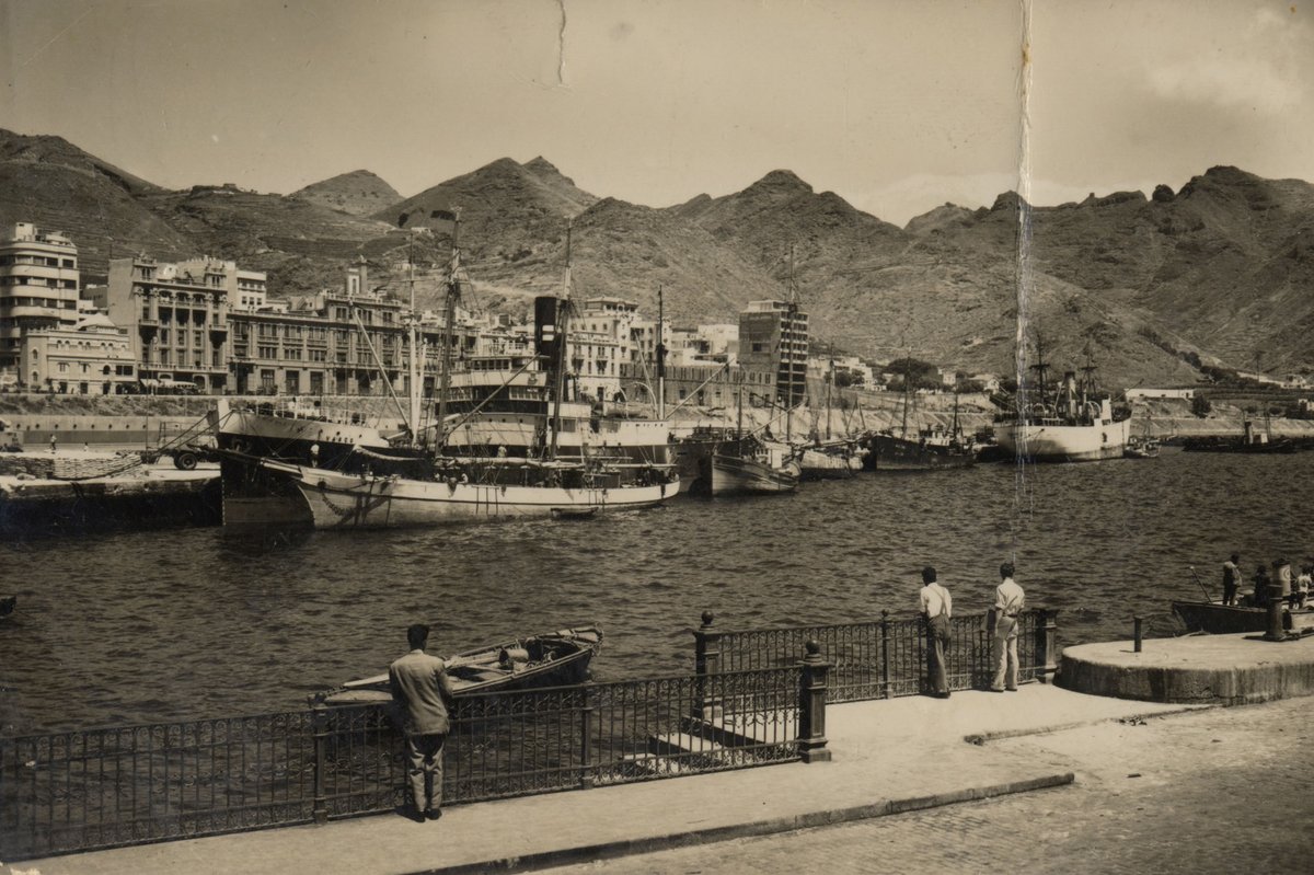 Santa Cruz de Tenerife harbor in the 1950s with vintage ships and waterfront buildings