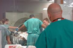 U.S. Navy physician assistant observes corpsmen preparing patient for CT scan at Los Angeles Navy Trauma Training Center