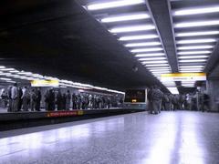Los Héroes metro station entrance with people and city background