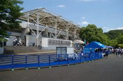 Machida-city athletic stadium with track and field facilities under a clear sky