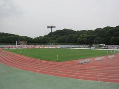 Machida Municipal Stadium exterior view with sports field and seating area